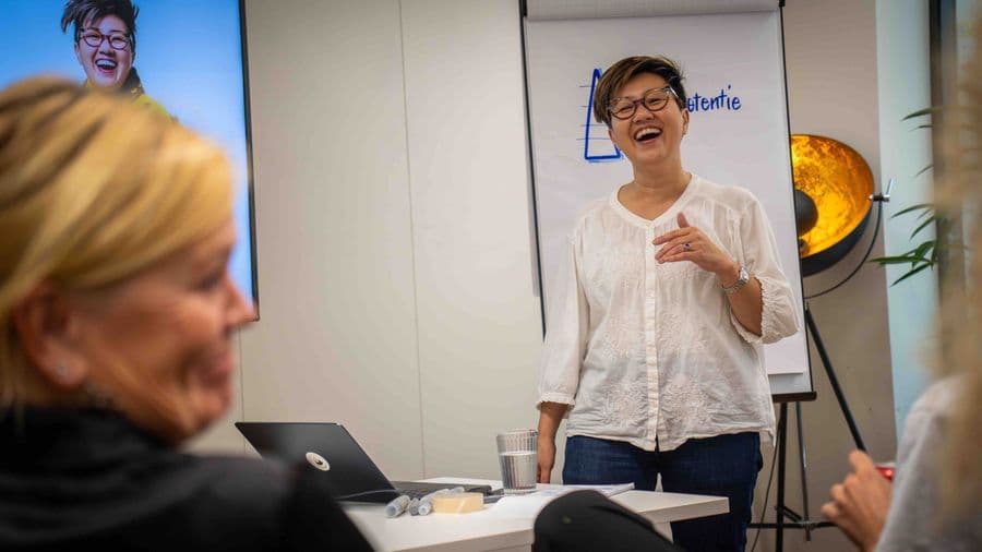 Yuen Yen laughing with participants